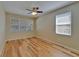 The spacious bedroom has two large windows, ceiling fan and wood flooring at 17510 Bright Wheat Dr, Lithia, FL 33547
