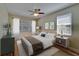 Bedroom features neutral colors, natural light, ceiling fan and hard wood flooring at 17510 Bright Wheat Dr, Lithia, FL 33547