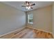 Bright bedroom with hardwood floors, ceiling fan, and window at 17510 Bright Wheat Dr, Lithia, FL 33547