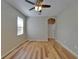 This empty bedroom has a ceiling fan, window and wood flooring at 17510 Bright Wheat Dr, Lithia, FL 33547