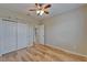Bedroom featuring hardwood flooring, a window, and a closet with shelving at 17510 Bright Wheat Dr, Lithia, FL 33547