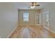 Bedroom featuring hardwood floors, ceiling fan, and glass paneled french doors at 17510 Bright Wheat Dr, Lithia, FL 33547