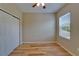 Bedroom featuring hardwood floors, a ceiling fan, window, and a closet at 17510 Bright Wheat Dr, Lithia, FL 33547