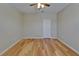 Bright bedroom featuring hardwood floors, a ceiling fan, and a white interior door at 17510 Bright Wheat Dr, Lithia, FL 33547