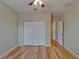 Bedroom with wood floor, ceiling fan, double closet and an adjacent room at 17510 Bright Wheat Dr, Lithia, FL 33547