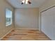 Bedroom featuring hardwood flooring, a window and a closet with white doors at 17510 Bright Wheat Dr, Lithia, FL 33547