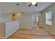 Bonus room with hardwood floors, ceiling fan, and access to window and interior rooms at 17510 Bright Wheat Dr, Lithia, FL 33547