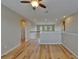 Bonus room with hardwood floors, ceiling fan, and staircase with white banister at 17510 Bright Wheat Dr, Lithia, FL 33547