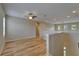 Bonus room featuring hardwood floors, ceiling fan, and access to upstairs living spaces at 17510 Bright Wheat Dr, Lithia, FL 33547