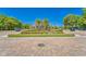 The community clubhouse with palm trees and accessible parking is framed by a beautiful brick driveway at 17510 Bright Wheat Dr, Lithia, FL 33547