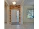 Elegant foyer with wood accent wall, tiled floor, and an arched doorway at 17510 Bright Wheat Dr, Lithia, FL 33547