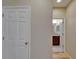 Hallway view with access to a powder room with modern vanity and framed mirror at 17510 Bright Wheat Dr, Lithia, FL 33547