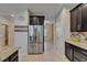Modern kitchen featuring stainless steel refrigerator and tile flooring at 17510 Bright Wheat Dr, Lithia, FL 33547