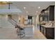 Modern kitchen featuring dark cabinets, granite countertops, and stainless steel appliances at 17510 Bright Wheat Dr, Lithia, FL 33547