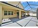 Rear exterior view of covered and screened lanai with an outdoor kitchen at 17510 Bright Wheat Dr, Lithia, FL 33547