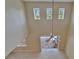 Open living area featuring vaulted ceilings, tile flooring, and sliding doors to the outside at 17510 Bright Wheat Dr, Lithia, FL 33547