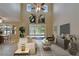 Bright living room with soaring ceilings, neutral decor, and sliding glass doors at 17510 Bright Wheat Dr, Lithia, FL 33547