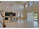 Spacious living room with kitchen views, high ceilings, and sliding doors at 17510 Bright Wheat Dr, Lithia, FL 33547