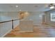 Upstairs loft area with wood floors, white railings, recessed lights and view to second story at 17510 Bright Wheat Dr, Lithia, FL 33547
