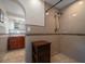 Shower with dual shower heads and decoratively tiled walls at 1963 Edgewater Dr, Clearwater, FL 33755