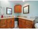 Bathroom with double sink, vanity, marble countertops, and wood cabinets at 1963 Edgewater Dr, Clearwater, FL 33755