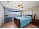 Cozy bedroom with lake view, ceiling fan, tile flooring, and a desk at 1963 Edgewater Dr, Clearwater, FL 33755