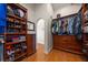 Walk-in closet features shelving, hanging rods, drawers, and mirror at 1963 Edgewater Dr, Clearwater, FL 33755