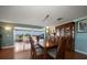 Formal dining room boasts hardwood floors and adjacent sunroom with water view at 1963 Edgewater Dr, Clearwater, FL 33755