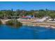 Charming waterfront home boasts a beautiful view, lush landscaping, and inviting curb appeal at 1963 Edgewater Dr, Clearwater, FL 33755