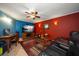 Comfortable living room featuring vibrant walls, tiled floors, ceiling fan, and entertainment setup at 1963 Edgewater Dr, Clearwater, FL 33755