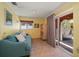 Living room with tile flooring, a blue sofa, sliding door to patio at 1963 Edgewater Dr, Clearwater, FL 33755