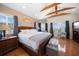 Bright main bedroom with wood floors, exposed ceiling beams, and water views at 1963 Edgewater Dr, Clearwater, FL 33755