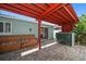 Outdoor patio area with bench seating, bar stools, and a view of lush greenery at 1963 Edgewater Dr, Clearwater, FL 33755