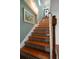 Stylish staircase with hardwood treads and decorative tiled risers, leading to the upper level at 1963 Edgewater Dr, Clearwater, FL 33755