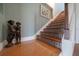 Staircase featuring tiled risers, hardwood treads, and natural lighting, adding character to the home at 1963 Edgewater Dr, Clearwater, FL 33755