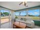 Bright sunroom featuring panoramic water views, comfortable seating, and tile floors at 1963 Edgewater Dr, Clearwater, FL 33755