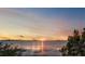Tranquil sunset over the water creates a picturesque scene with a beautiful sky at 1963 Edgewater Dr, Clearwater, FL 33755