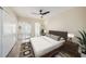 A modern bedroom with neutral tones, a large bed, and sliding doors to a balcony or patio at 2002 Australia E Way # 66, Clearwater, FL 33763