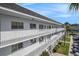 Three-story building exterior with white railings, offering balconies and multiple windows at 2002 Australia E Way # 66, Clearwater, FL 33763