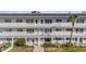 Exterior view of a well-maintained building, showcasing walkways and manicured landscaping at 2002 Australia E Way # 66, Clearwater, FL 33763