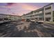 A well-maintained condo complex featuring ample parking and balconies, set against a stunning sunset sky at 2002 Australia E Way # 66, Clearwater, FL 33763