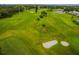 Aerial view of a beautifully maintained golf course with sand traps and lush green fairways at 2002 Australia E Way # 66, Clearwater, FL 33763