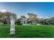 Serene outdoor space with statue, colonnade, and green lawn, perfect for relaxation and contemplation at 2002 Australia E Way # 66, Clearwater, FL 33763