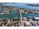 Expansive aerial view of a waterfront community with lush landscaping, a bridge, and beautiful waterways at 2100 Pass A Grille Way, St Pete Beach, FL 33706