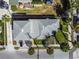 Aerial shot of a home showcasing roof, landscaping, and proximity to the street and surrounding neighborhood at 2100 Pass A Grille Way, St Pete Beach, FL 33706