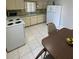 Bright eat-in kitchen featuring white appliances and tile flooring at 2100 Pass A Grille Way, St Pete Beach, FL 33706