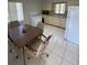 Bright eat-in kitchen featuring white appliances and tile flooring at 2100 Pass A Grille Way, St Pete Beach, FL 33706