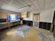 A kitchen features outdated cabinets and fixtures, and damaged walls and floors at 2100 Pass A Grille Way, St Pete Beach, FL 33706
