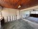 A living room featuring wood paneling and damaged drywall and ceiling at 2100 Pass A Grille Way, St Pete Beach, FL 33706