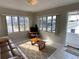 Cozy living room with tile floors, comfortable sofa, and lots of natural light from multiple windows at 2100 Pass A Grille Way, St Pete Beach, FL 33706